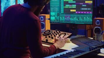 Audio engineer inserting an usb stick in the pc to record himself playing piano, mixing sounds and adjusting volume levels. Artist mastering audio recordings ready for release. Camera A. photo
