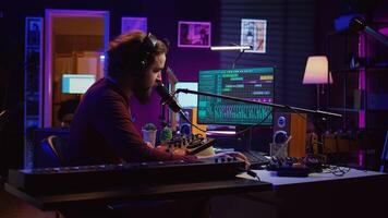 Music producer recording piano instrument and vocals to edit a new song, adjusting volume levels an adding audio effects. Sound engineer working with his mixing console and equipment. Camera B. photo