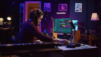 Music producer editing and mixing audio tracks on daw software, recording audio too loud with acoustical engineering technology. Sound engineer producing high quality recordings. Camera B. photo