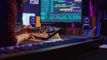 Sound engineer mixing and mastering sounds with electronic audio console, pressing controls and pre amp knobs. Music producer improving sound quality, synchronize soundtracks. Camera B. photo