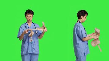 Nurse explaining use of cervical collar in case of spine or neck fracture, showing medical brace that helps with injury rehabilitation. Physical therapy specialist holds orthopedics tool. Camera B. photo