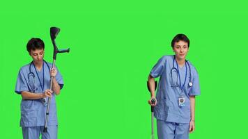 Hospital staff worker assembling crutches to help with mobility and healing, preparing walking tool for someone with broken leg. Medical assistant helping patient with fracture. Camera B. photo