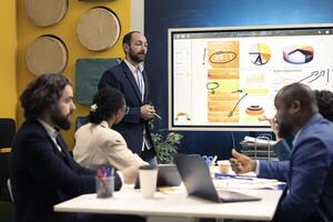 Marketing team attend an information sharing conference to verify updates on regulatory changes or industry standards. Business professionals reviewing all data analysis statistics. photo