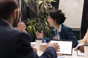 Administrative group discussing agenda for upcoming events coordinated, looking for expansion opportunities in a global collaboration. Multinational business development plans. photo