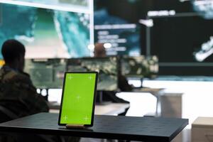 Isolated green screen display running on a tablet in federal army division base, troopers monitor reconnaissance imagery to stay alert in case of a hostile attack. Radar system for national safety. photo