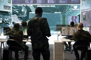 Infantry unit trooper analyzing intelligence gathered from satellite system, military command post activity. Soldier comparing the data between case files and big screen, examines information. photo