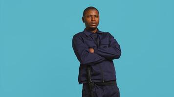 Security guard in threatening pose, tasked with preventing criminal activity and detaining suspects performing crimes. Portrait of menacing bodyguard crossing arms, studio background, camera B photo