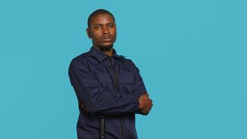 Security guard doing salute hand gesture, preparing to start job of deterring criminals. Portrait of bodyguard doing greeting gesturing and military pose, studio background, camera A photo