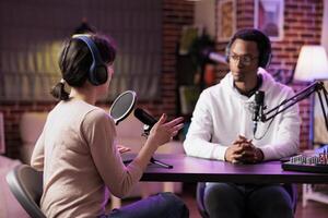 African american podcast host discussing with guest during live broadcast for social media website, listening to her story. Internet star using professional equipment to record chat photo