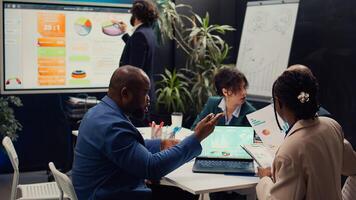 Diverse team of specialists developing corporate communications strategies, working together to ensure goals and achievements. Manager and employees collaborating on new project. Camera B. photo