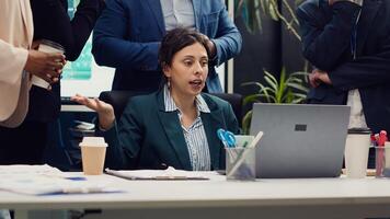 Employees team showing their project updates to the supervisor, crazy manager yelling at her staff members and being displeased with their progress. Disappointed leader judging associates. Camera A. photo