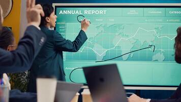 Office administrator presenting data reports and funding on interactive board, deliberating on income analysis with her associates. Accomplishing enterprise financial objectives. Camera A. photo