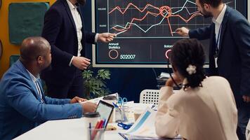 Marketing team attending a tensed meeting to review sales trends on interactive board, looking for ways to increase the organization profit and ensure global success. PR specialists. Camera A. photo