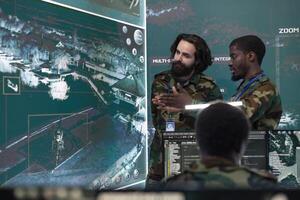 Professional IT specialists collect information for field operations, using federal satellite imagery on CCTV system in military base. Troopers checks important real time data on a big screen. photo