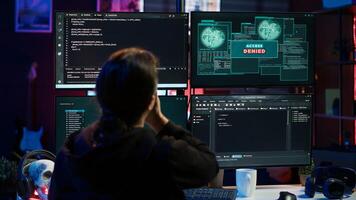 Hacker getting access denied error while doing computer sabotage using ransomware. Cybercriminal failing to penetrate firewalls while trying to steal victim data, camera A photo