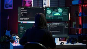 Happy man writing code on PC, celebrating after managing to get past security systems. Hacker using computer to make scripts that can hack devices, feeling proud after breaching firewall, camera A photo