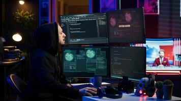 Frustrated hacker in secret hideout dejected after failing to attack victims using malware. Annoyed scammer feeling upset after being unable to hack computer systems, camera A photo