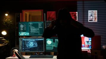 Hackers found by cybercriminal law enforcement escaping with stolen data on SSD after failing to conceal online identity. Criminal in hideout running from police after hacking into servers, camera A photo