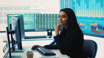 Indian sales manager verifies infographics plan in company coworking space, works on creating business strategies and goals. Employee studying market dynamics and big data. Camera A. photo