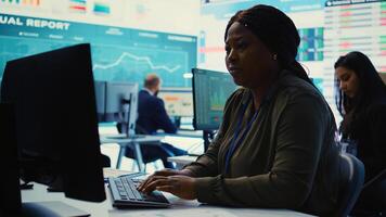 Enterprise manager analyzes annual reports and statistics on a pc, works on creating business strategies and goals. Analyst studying market dynamics and organizational progress. Camera B. photo