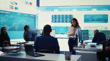 Executive consultant gathers his staff to discuss about performance metrics, looking for ways to improve the workflow in order to achieve business goals and expand on global scale. Camera B. photo