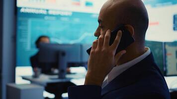 Business analyst does a presentation with project updates on phone call, discussing with CEO to ensure organizational success. Employee allocating resources according to the market needs. Camera B. photo