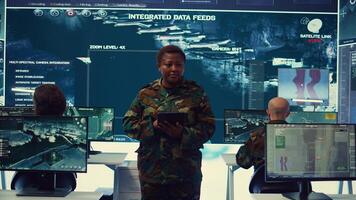 Woman sergeant major working on deployment of electronic warfare tools to disrupt enemy communications. Female army soldier with camouflage uniform operating on high tech gear. Camera B. photo