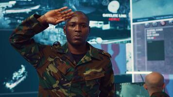 Military officer presenting the official custom salute etiquette, embodying discipline and respect. Federal army general saluting and greeting the crew captain in command center. Camera A. photo