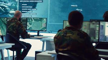 Group of soldiers managing air and sea traffic control for military operations success, working together in federal command post. National surveillance systems using satellite radar. Camera A. photo