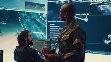 Navy captain oversees collecting important data for a national defense mission, targeting enemy vessels with the satellite radar system. Reconnaissance in a military base of operations. Camera B. photo