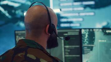 Military operator transmitting gps coordinates of hostile ships to national guard, providing real time data from surveillance CCTV system. Army officer works in power base control center. Camera A. photo