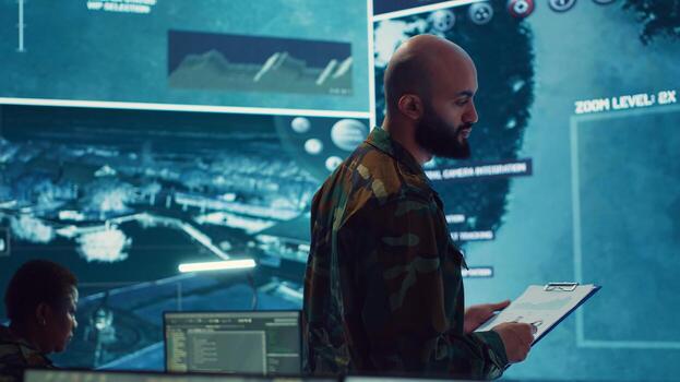Army officer examining real time satellite data on big screen in military power base, gather intelligence on enemy vessels trajectory. Federal defense program specialist commanding troops. Camera A. photo