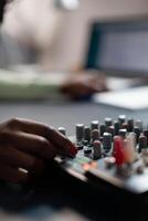 Closeup of vlogger woman checking sound of mixer while recording online vlog talking with subscribers using vlogging microphone. Content creator filming for social media. On air talk show photo