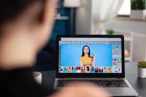 Freelancer photo editor working from home office. Student retouching photos on laptop using editing software. Creative artist working remote creating digital art with digital tools.