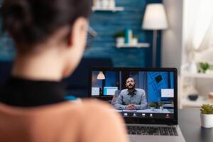 Student using laptop for videocall with teacher. Candidate attending online interview with employer. Freelancer working from home office in call with client. Online webinar conference. photo