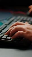 Close-up on hands of pro cyber man playing game using RGB keyboard. Virtual championship in cyberspace, esports player performing on powerful computer during online esports gaming tournament photo