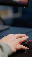 Close-up of man hands gamer playing game using RGB keyboard during virtual championship in cyberspace. Online streaming cyber performing on powerful personal computer during gaming tournament photo