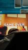 Back view of sad professional eSports gamer losing shooter mock-up game. Defeated man with headphones streaming online cyber performing during gaming tournament using powerful personal computer photo