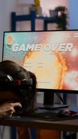 Pro woman gamer losing space shooter game competition on professional powerful computer with wireless controller. Professional player streaming online game using professional joystick and headset photo