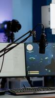 Empty gaming studio with RGB led lights powerful personal computer for streaming online competition. Display with stream chat prepared for virtual tournament, living room with nobody in photo