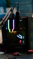 Game is over on display of RGB professional powerful computer and stream chat is prepared for virtual tournament. Streaming professsional microphone in empty gaming home studio with neon lights. photo