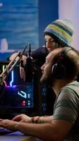 Excited players couple winning online videogames competition using powerful computer celebrating victory. Streamer gamer playing games with RGB keyboard performing at gaming turnament photo