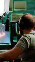 Man streamer playing space shooter videogame using headset, talking on stream chat and microphone. Online streaming cyber performing on RGB powerful professional computer during gaming tournament photo