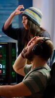 Nervous players couple losing online videogames competition using powerful computer screaming at each other. Streamer gamer playing games with RGB keyboard performing at gaming turnament photo
