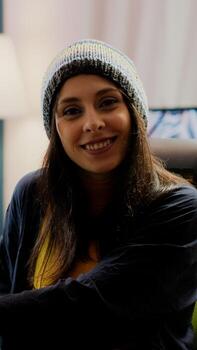 Portrait of woman streamer looking at camera after playing space shooter games using professional RGB keypad on powerful computer. Pro player streaming online videogames in gaming home studio photo
