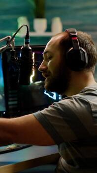 Professional cyber streamer playing online videogames on professional powerful computer with green screen mock up, chroma key display. Gamer playing space shooter game with isolated desktop streaming photo