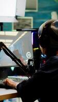 Pro streamer checking sound on mixer putting on headset and start playing FPS game during virtual competition. Gamer using professional streaming setup, stream chat in gaming home studio photo