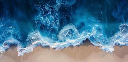 Aerial View of Turquoise Ocean Waves Breaking on Sandy Beach photo
