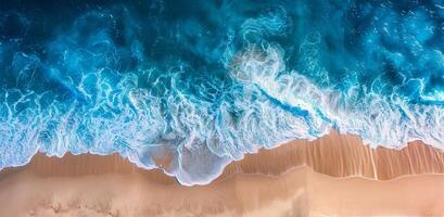 Aerial View of Turquoise Ocean Waves Breaking on Sandy Beach photo