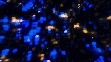Blue and white illuminated lanterns. Motion. Moving light on a calm black background made in abstraction. video